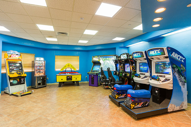 Interior shot of the arcade room at our family resort in Kissimmee, FL. Arctic snow mobile racing arcade game, air hockey, and more